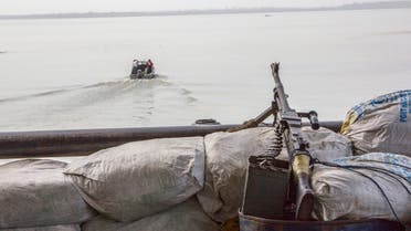 A machine gun is seen on a sandbag on a boat off the Atlantic coast in Nigeria's Bayelsa state December 19, 2013. (Reuters)