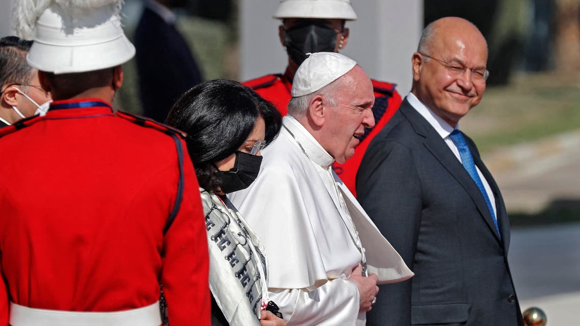 Iraq's President Barham Saleh (R) and his wife Sarbagh (L) escort Pope Francis (C) during the farewell ceremony for the pontiff at the Iraqi capital's Baghdad International Airport on March 8, 2021. (AFP)