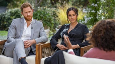 This undated image released March 7, 2021 courtesy of Harpo Productions shows Britain's Prince Harry (L) and his wife Meghan (C), Duchess of Sussex, in a conversation with US television host Oprah Winfrey. (AFP)