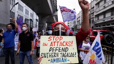 A woman activist displays a slogan condemning the recent government attacks on activists as they hold a rally near the Malacanang presidential palace to mark International Women’s Day on March 8, 2021, in Manila, Philippines. (Reuters)