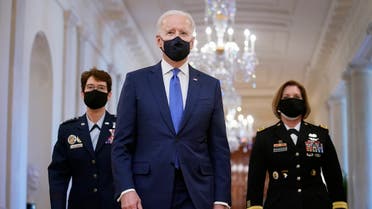 President Joe Biden walks with Air Force Gen. Jacqueline Van Ovost, left, and Army Lt. Gen. Laura Richardson before speaking at an event to mark International Women's Day, Monday, March 8, 2021, in the East Room of the White House in Washington. (AP)