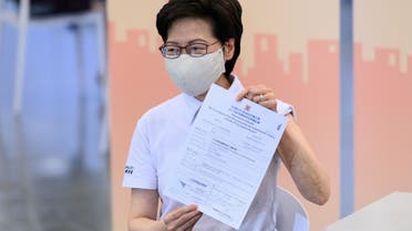 Hong Kong's Chief Executive Carrie Lam holds up a certificate after receiving China's Sinovac COVID-19 coronavirus vaccine at the Community Vaccination Centre in Hong Kong on February 22, 2021. (File photo: AFP)