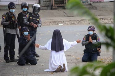 March 9 by the Myitkyina News Journal shows a nun pleading with police not to harm protesters in Myitkyina in Myanmar's Kachin state, amid a crackdown on demonstrations against the military coup. (File photo: AFP)