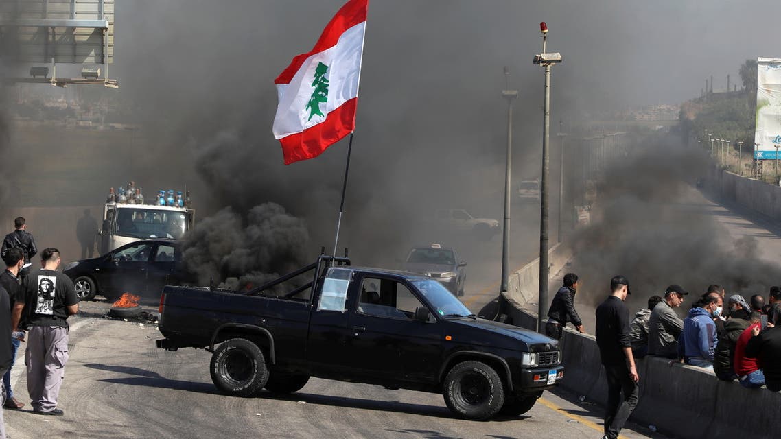 A vehicle blocks a road during a protest against the fall in Lebanese pound currency and mounting economic hardships in Khaldeh, Lebanon March 8, 2021. (Reuters)