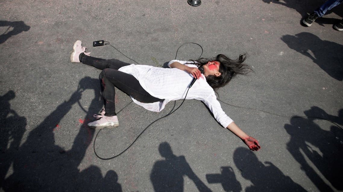 A woman performs an act against the growing incidents of violence on women during the International Women's Day in Kathmandu, Nepal March 8, 2021. (Reuters/Navesh Chitrakar)