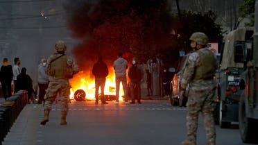 Lebanese protesters burn tires in the southern Lebanese city of Sidon on March 8, 2021. (AFP)