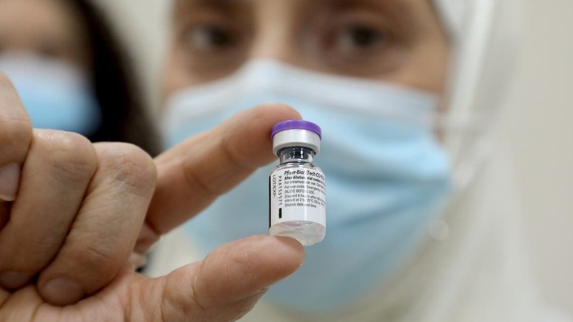 A healthcare worker holds a vial of the Pfizer-BioNTech coronavirus disease (COVID-19) vaccine at Rafik Hariri University Hospital, in Beirut, Lebanon, on February 14, 2021. (Reuters)