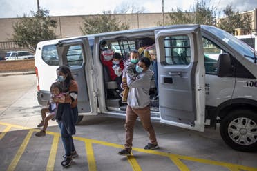 Asylum seekers are released by the US Border Patrol at a bus station on February 26, 2021 in Brownsville, Texas. (AFP)