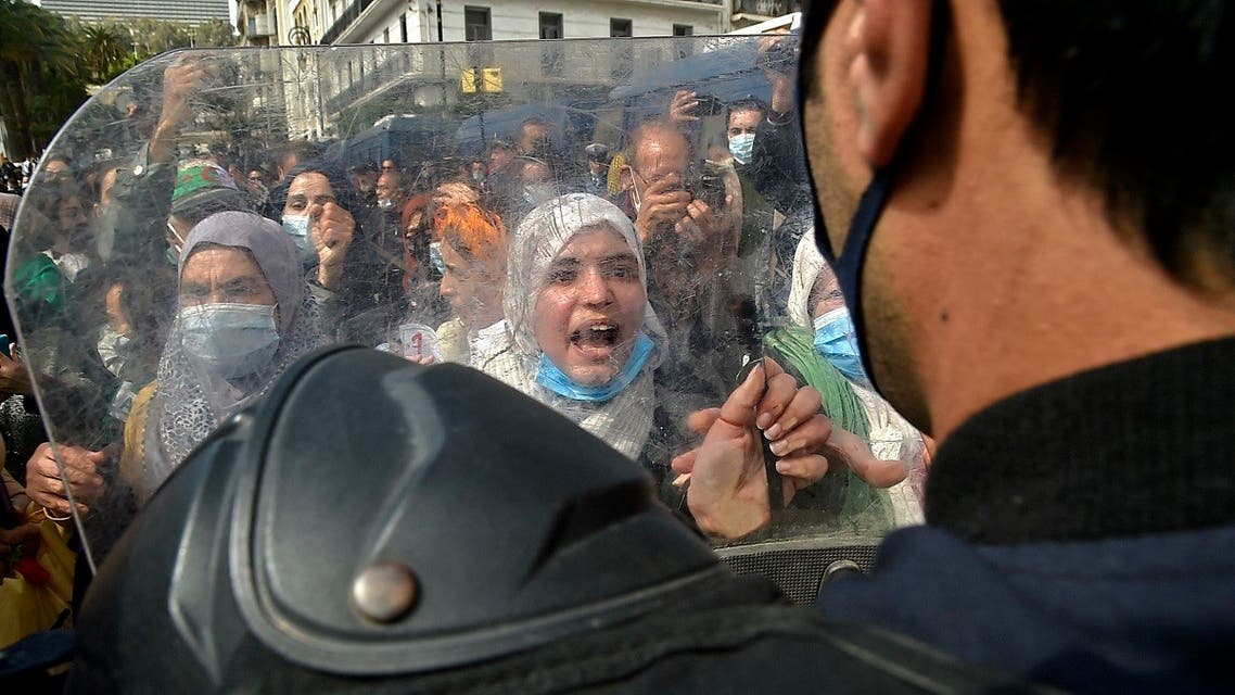 Algerian women chant slogans during an anti-government protest in the capital Algiers on March 8, 2021. (Ryad Kramdi/AFP)