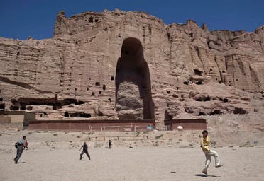 Afghan boys play soccer in front of the remains of a 1,500-year-old Buddha statue which was destroyed by the Taliban in March 2001, in the central province of Bamiyan August 22, 2011. (Reuters)