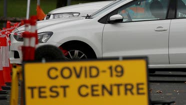 An NHS test and trace worker talks to a driver at a drive-through testing centre following the outbreak of the coronavirus disease (COVID-19) in Bolton, Britain, September 22, 2020. (Reuters/Phil Noble)