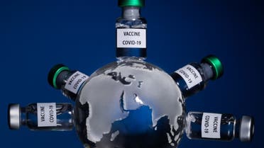 This picture taken on January 11, 2021 shows the globe with vaccine vials reading Covid-19 vaccine in Paris. (AFP)