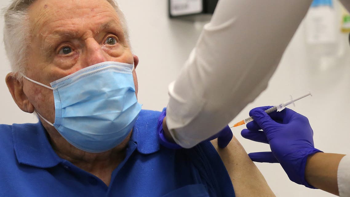 John Healy, a resident of the Wesley Taylor aged care facility, becomes the second person in Australia to receive a dose of the Pfizer/BioNTech Covid-19 vaccine at the Castle Hill Medical Centre in Sydney on February 21, 2021. STEVEN SAPHORE / AFP