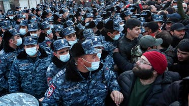 Police wearing face masks to protect against coronavirus, block opposition demonstrators during a rally to pressure Armenian Prime Minister Nikol Pashinyan to resign in Yerevan, Armenia, Tuesday, March 9, 2021. (AP)