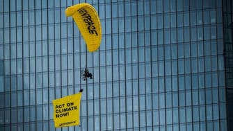 Greenpeace activist paragliders land on ECB building in climate protest