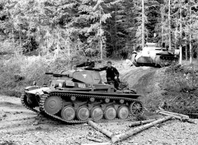 A photograph of a number of German tanks advancing on French territory in 1940
