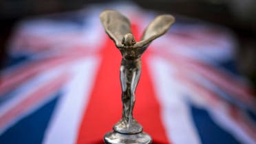 he Rolls-Royce's iconic mascot Spirit of Ecstasy decorates the bonnet of a Rolls-Royce limousine adorned with a Union Jack during the 23rd Swiss Classic British Car Meeting. (File photo: AFP) 