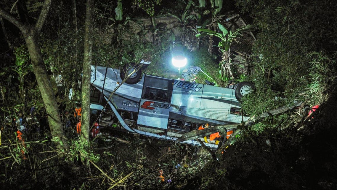 Rescuers evacuating victims of a bus accident that plunged into a ravine in Wado subdistrict, in Sumedang, West Java. (AFP)