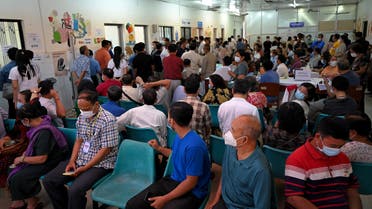 People gather as they wait to receive the Sinopharm and AstraZeneca vaccines against the Covid-19 coronavirus at a hospital in Phnom Penh on March 10, 2021. (AFP)