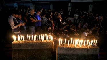 Lebanese anti-government protesters take part in a candle light vigil outside the headquarters of Lebanon Electricity company (EDL) in Beirut. (File photo: AFP)