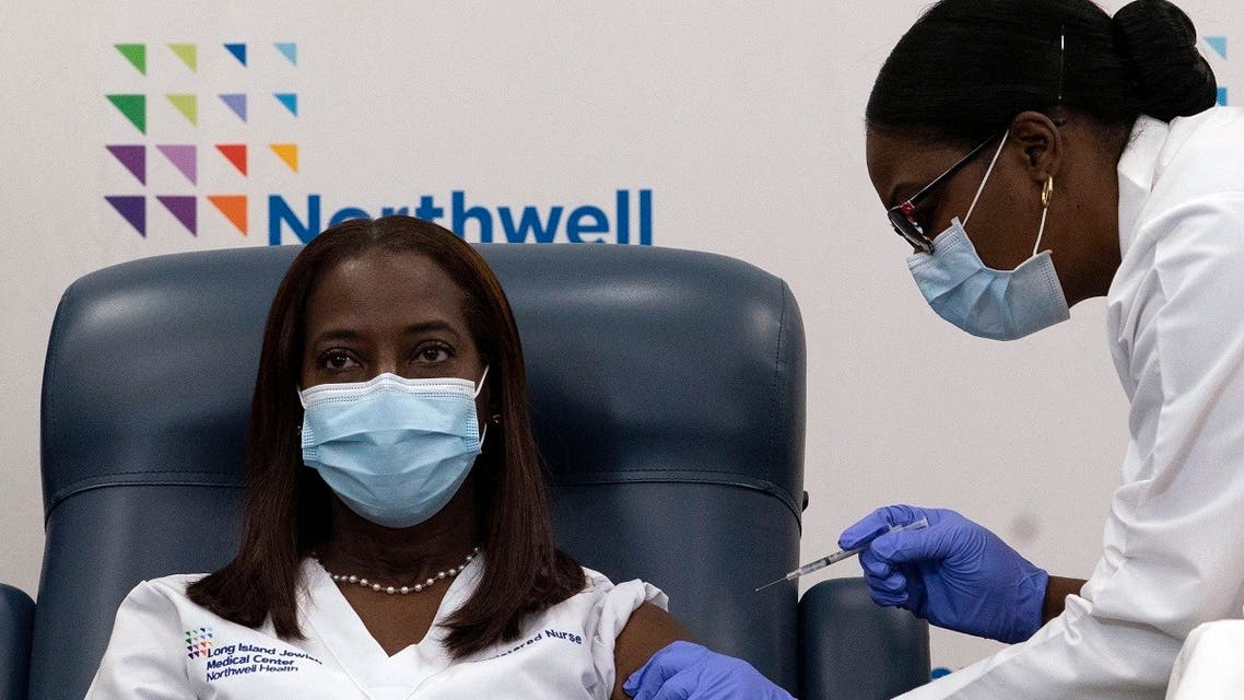 In this file photo taken on December 14, 2020, Sandra Lindsay (L), a nurse at Long Island Jewish Medical Center, is inoculated with the COVID-19 vaccine by Dr. Michelle Chester, at Long Island Jewish Medical Center, in the Queens borough of New York. (Mark Lennihan/Pool/AFP)