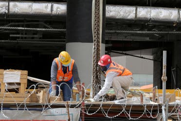 Foreign workers wearing protective face masks and gloves work at a construction site, following the outbreak of the coronavirus disease (COVID-19), in Riyadh, Saudi Arabia, May 7, 2020. (Reuters)