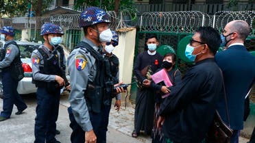 Myanmar police talk to people gathering outside the Kamayut court in Yangon, Myanmar Friday, March 12, 2021. (AP)
