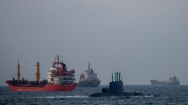An Israeli military submarine sails past cargo ships in the Mediterranean Sea, Israel, Tuesday, Sept. 29, 2020. (AP)