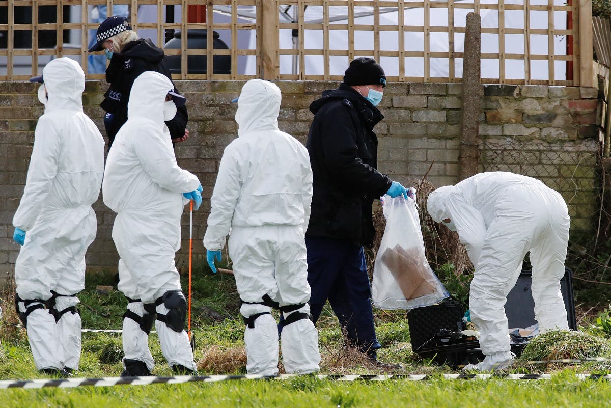 Police officers search an area of grass land behind a house, as the investigation into the disappearance of Sarah Everard continues, in Deal, Britain. (Reuters)