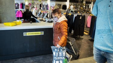 Customers walk in a clothing store in Klazienaveen on March 2, 2021, which is open in defiance of the authorities current guidelines as the coronavirus pandemic continues. (Vincent Jannink/ANP/AFP)