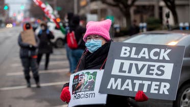 Protesters hold signs and flags during a demonstration against police brutality in front of the Fraternal Order of Police in Columbus, Ohio on December 28, 2020. (File photo: AFP)