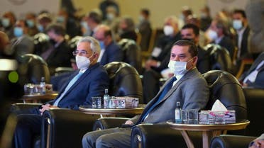 Libya’s interim prime minister Abdul Hamid Dbeibah (R) attends a national conference on the COVID-19 pandemic, at a conference hall in the capital Tripoli, on March 13, 2021. (Mahmud Turkia/AFP)
