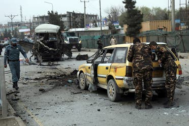 Security personnel inspect the site of a bomb attack in Kabul, Afghanistan, March 15, 2021. (AP/Rahmat Gul)