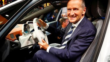Herbert Diess, CEO of German carmaker Volkswagen AG, poses in an ID.3 pre-production prototype during the presentation of Volkswagen's new electric car on the eve of the International Frankfurt Motor Show IAA in Frankfurt, Germany, on September 9, 2019. (Reuters)
