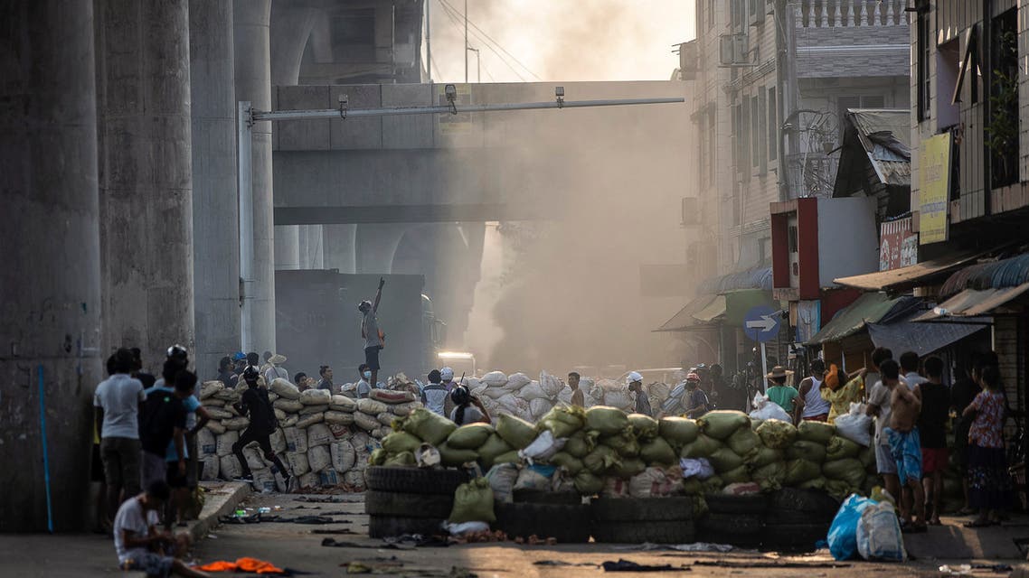 Protesters stand near makeshift barricades during demonstrations against the military coup in Yangon on March 15, 2021. (File photo: AFP)