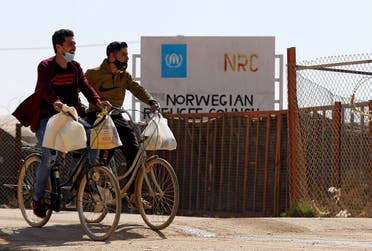 Syrian refugees ride their bicycles in the Zaatari refugee camp, 80 kilometers (50 miles) north of the Jordanian capital Amman on February 15, 2021. (Khalil Mazraawi/AFP)