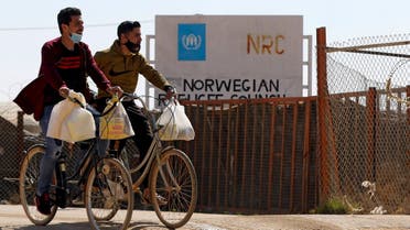 Syrian refugees ride their bicycles in the Zaatari refugee camp, 80 kilometers (50 miles) north of the Jordanian capital Amman on February 15, 2021. (Khalil Mazraawi/AFP)