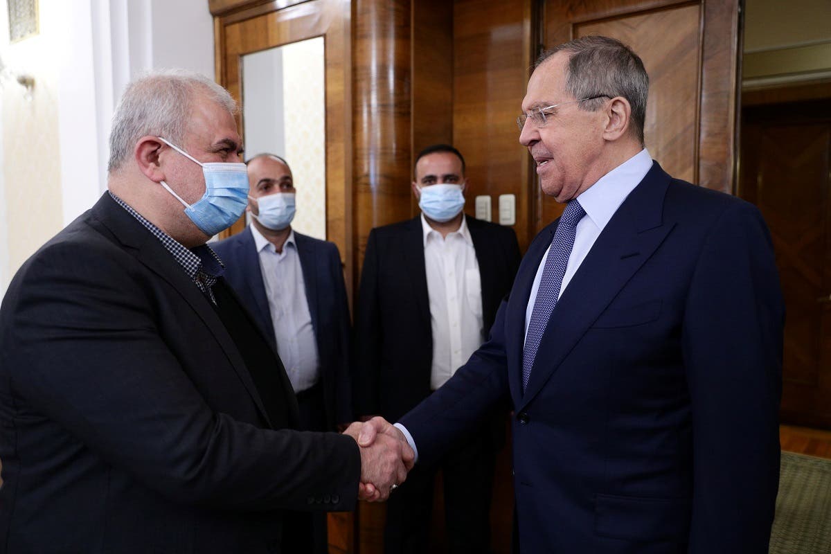 Russia's Foreign Minister Sergei Lavrov shakes hands with Mohammad Raad, the head of the parliamentary bloc of Lebanon's Hezbollah, in Moscow, March 15, 2021. (Reuters)