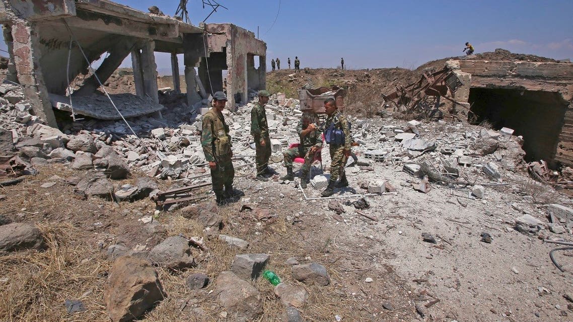 A picture taken on July 22, 2018, during a government guided tour, shows Syrian regime forces gathering on al-Jabieh hill, during their advance on the town of Nawa, in the southern province of Daraa. (Youssef Karwashan/AFP)