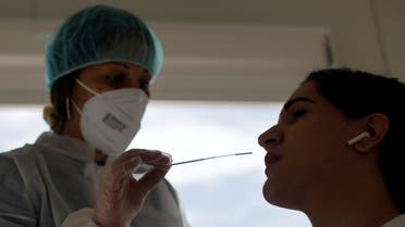 A medical worker administers a nasal swab to a patient at a COVID-19 mobile test centre called MobilTest COVID at Nice railway station, as part of the coronavirus disease (COVID-19) testing campaign in Nice, France, March 12, 2021. REUTERS/Eric Gaillard