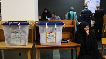 Electoral employees sits next to ballot boxes before closing vote for the presidential election in a polling station in Tehran, Iran, May 19, 2017. TIMA via REUTERS ATTENTION EDITORS - THIS IMAGE WAS PROVIDED BY A THIRD PARTY. FOR EDITORIAL USE ONLY.