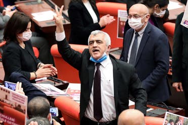 Turkish member of Parliament for the left wing political party Peoples' Democratic Party Omer Faruk Gergerlioglu (C) reacts after he was dismissed following a vote at the Turkish Parliament in Ankara, on March 17, 2021. (Adem Altan/AFP)