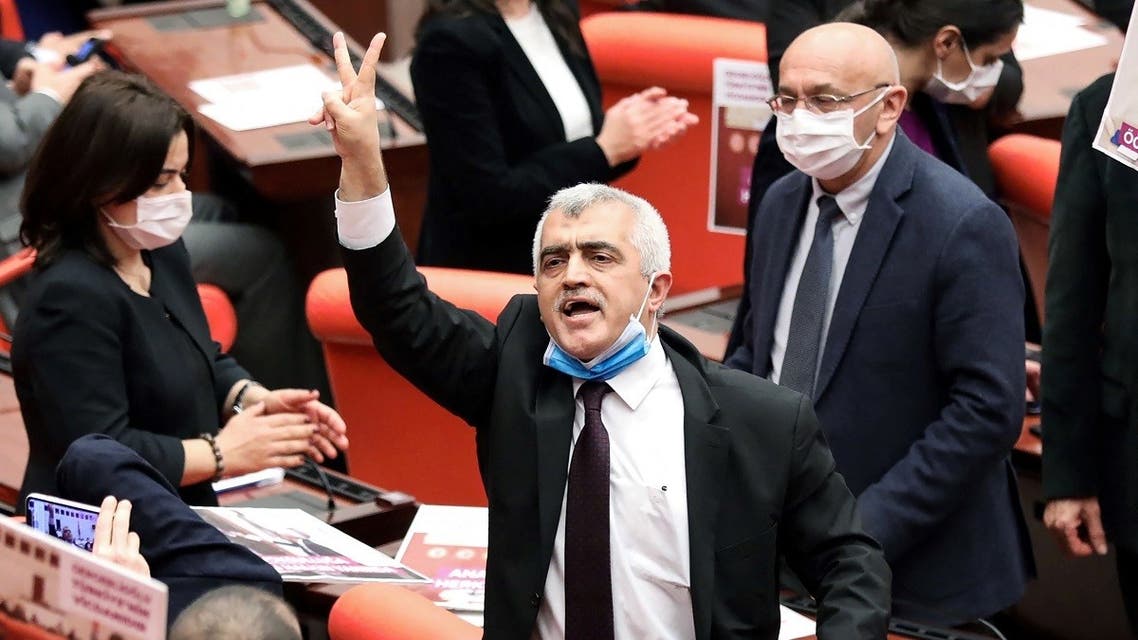 Turkish member of Parliament for the left wing political party Peoples' Democratic Party Omer Faruk Gergerlioglu (C) reacts after he was dismissed following a vote at the Turkish Parliament in Ankara, on March 17, 2021. (Adem Altan/AFP)