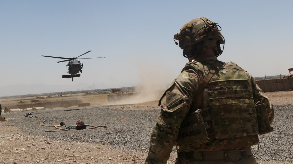 A US soldier assigned to the Headquarters and Headquarters Battalion, 1st Armored Division watches as a UH-60 Blackhawk Helicopter prepares to land during an advise and assistance mission in southeastern Afghanistan, August 4, 2019. (Reuters)