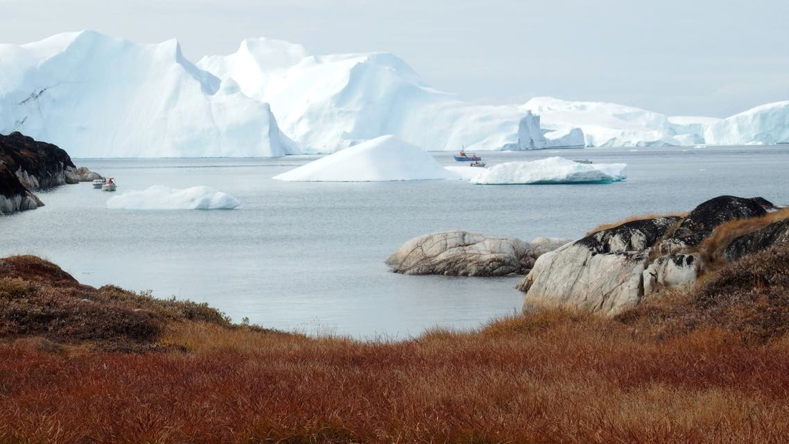 Fishing vessels are seen next to the icebergs near Ilulissat, Greenland September 13, 2017. Picture taken September 13, 2017. REUTERS/Jacob Gronholt-Pedersen