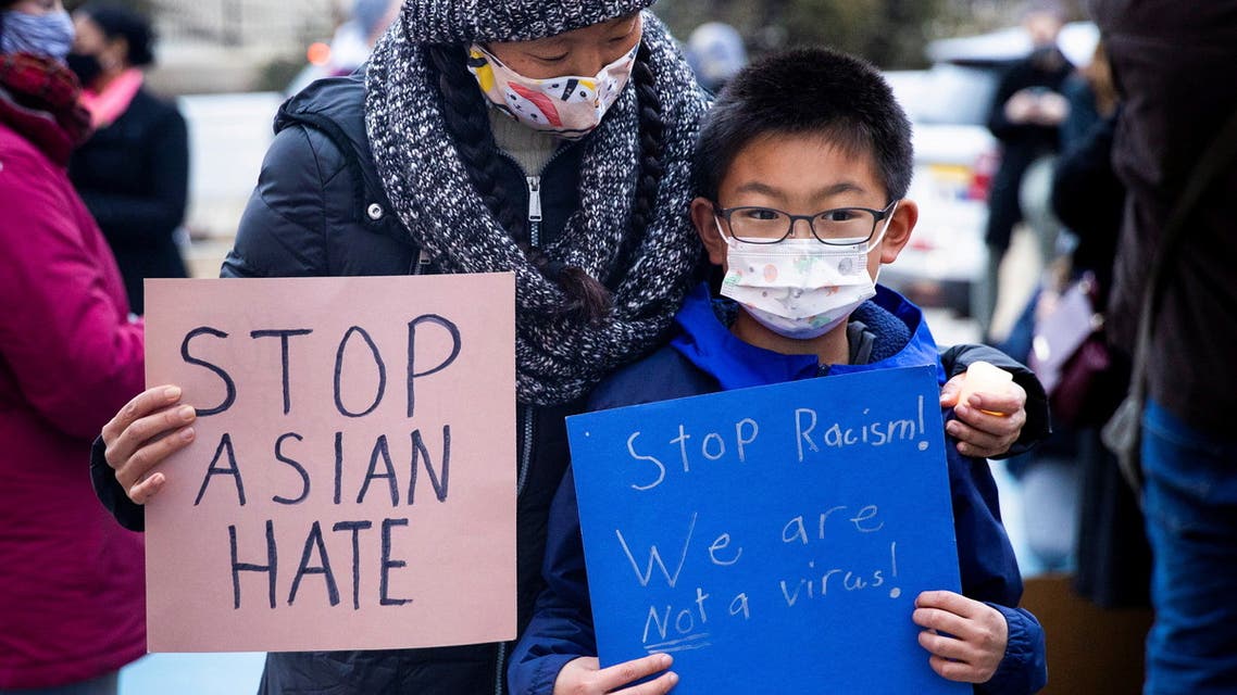 Melissa Min (L) attends a vigil with her son James in solidarity with the Asian American community after increased attacks on the community since the onset of the coronavirus pandemic a year ago. (Reuters)
