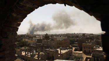 Smoke and dust rise near buildings in Sanaa, Yemen March 7, 2021. (Reuters)