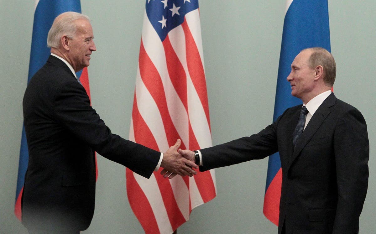 Now-Russian President Vladimir Putin (R) shakes hands with now-US President Joe Biden in Moscow March 10, 2011. (Reuters)