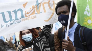Protestors hold a Unef students union's banner during a demonstration of young people against the precariousness of students, accentuated by the Covid-19, in Paris on March 16, 2021. (AFP)