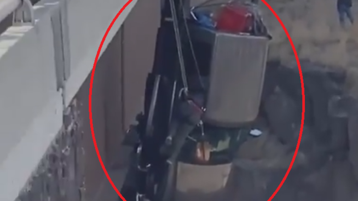 How were 2 people rescued from a truck floating in the air on the bridge?